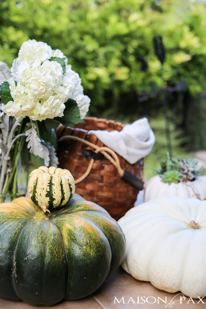 10 tips for a magical outdoor dining table: lanterns, string lights, apple candles, and other cozy outdoor fall decorating ideas!