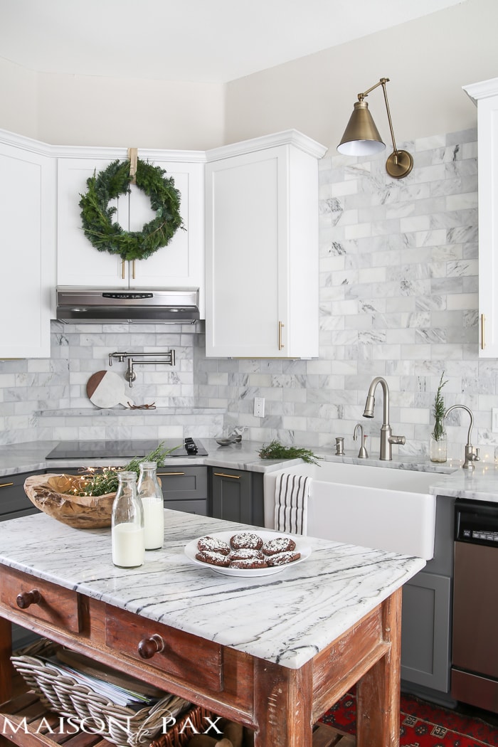 Gorgeous two-tone kitchen design with white upper cabinets, gray lower cabinets, carrara marble counters and marble subway tile backsplash- Maison de Pax