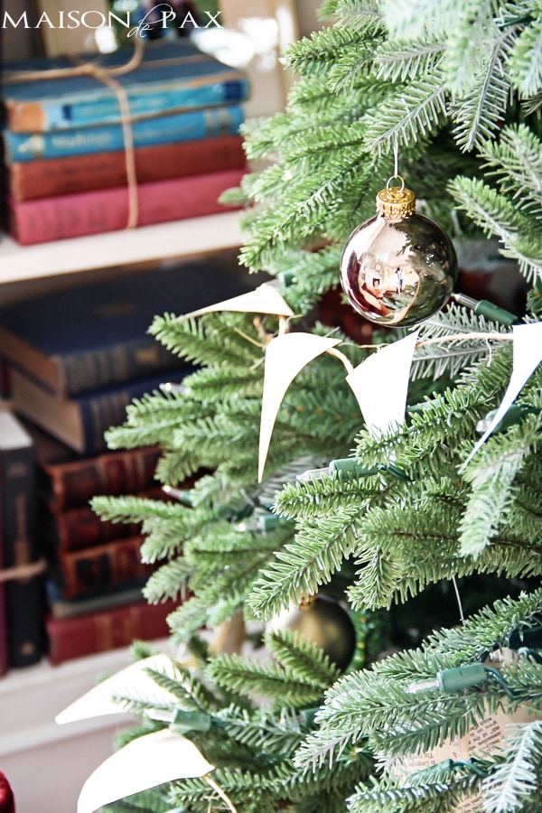 Love this simple Christmas tree decorating idea! Book page bunting and ornaments with stenciled words... Simple and beautiful! via aiweb9ygdry.cmersite.com