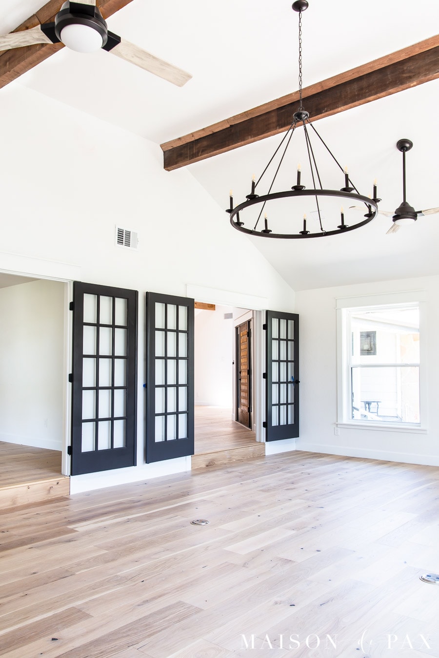 black french doors and black fans with whitewashed blades