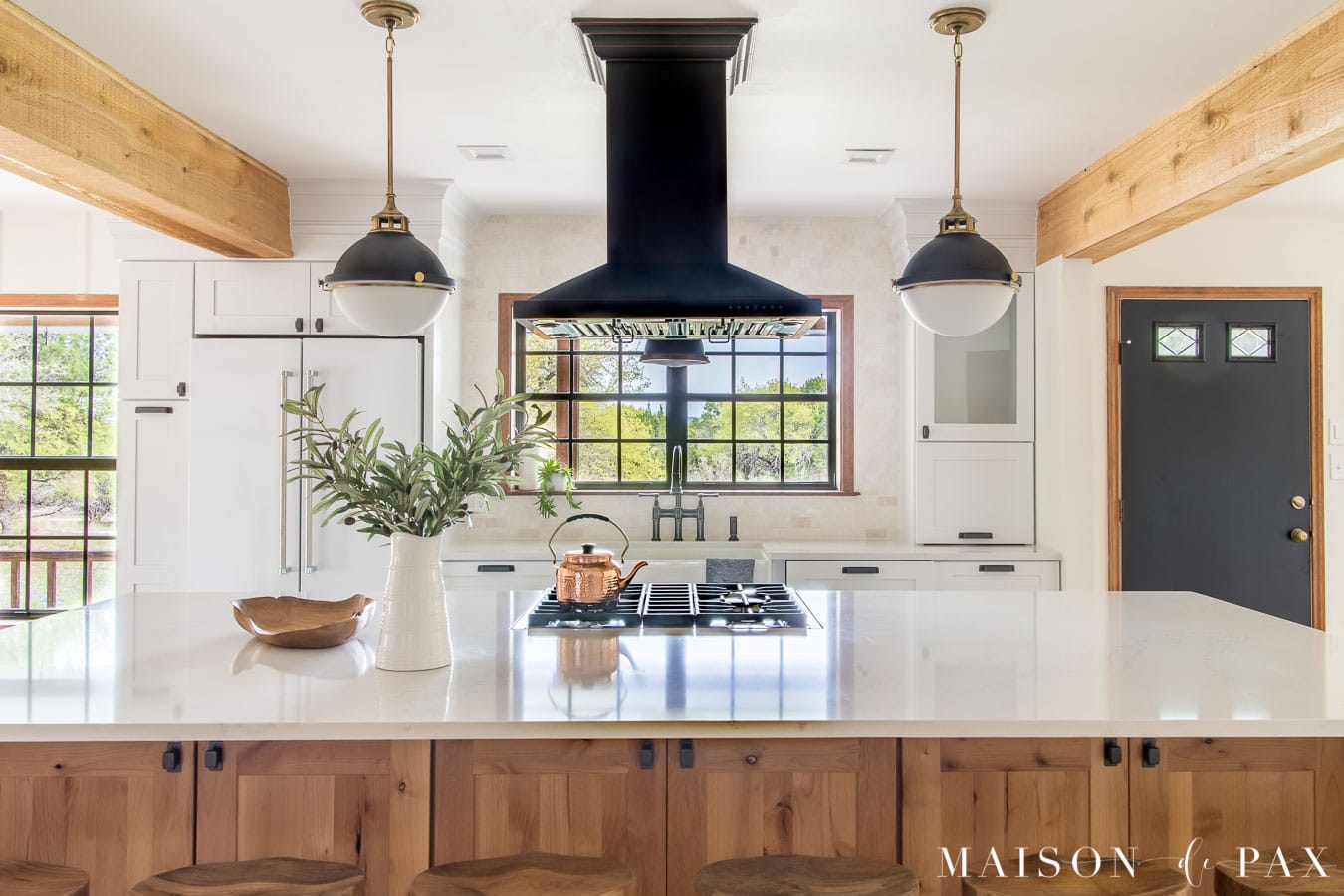 large kitchen island with white quartz counter and island range | Maison de Pax