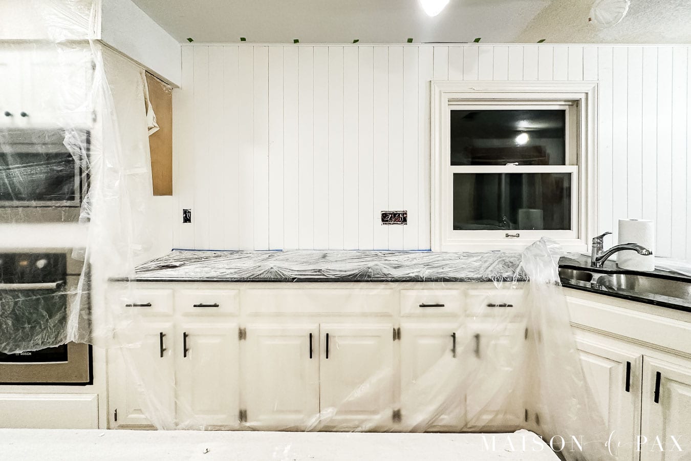 studs marked with painters tape before installing paneling