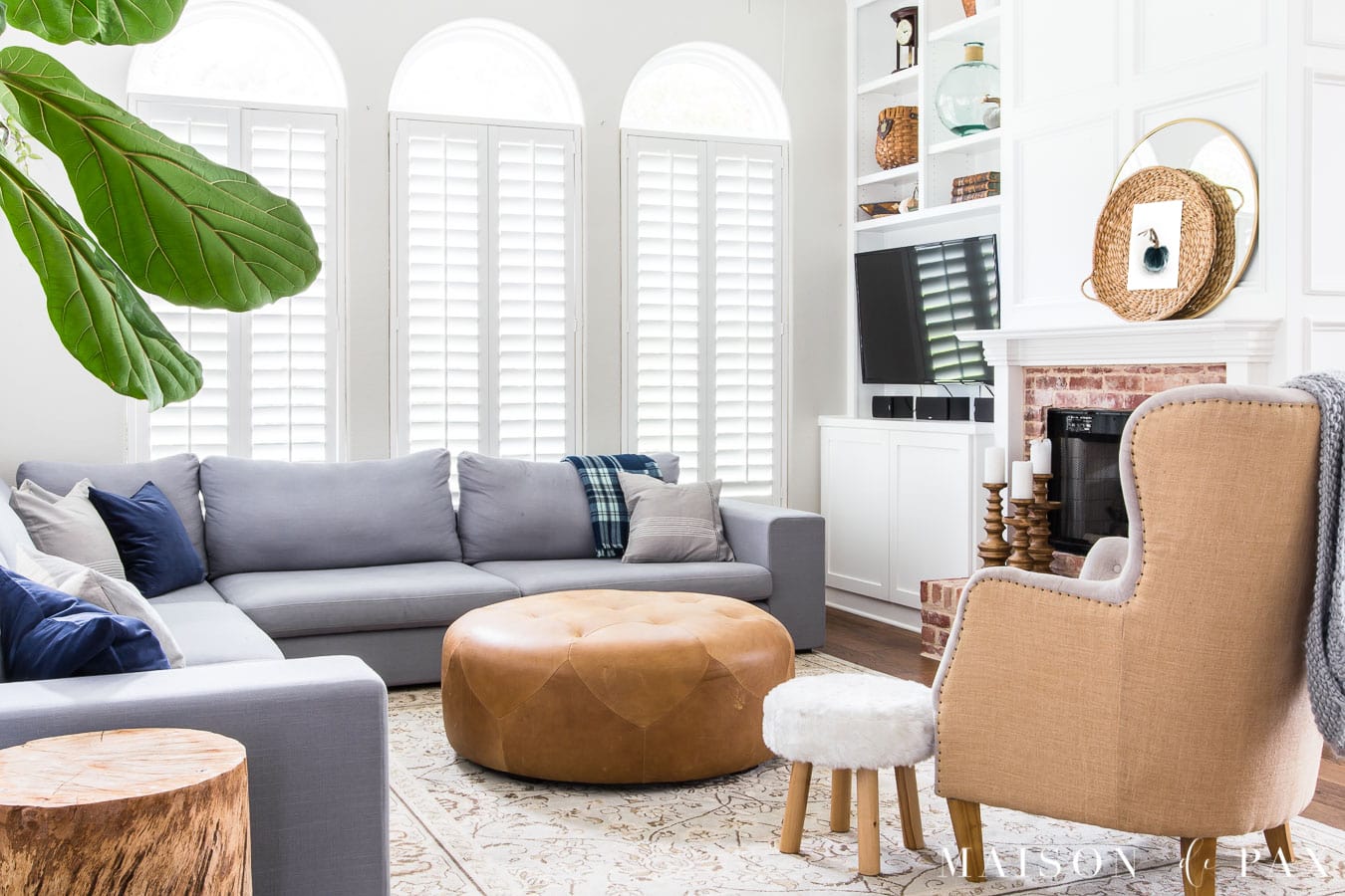 light gray living room with gray sectional and warm neutral accents - Maison de Pax