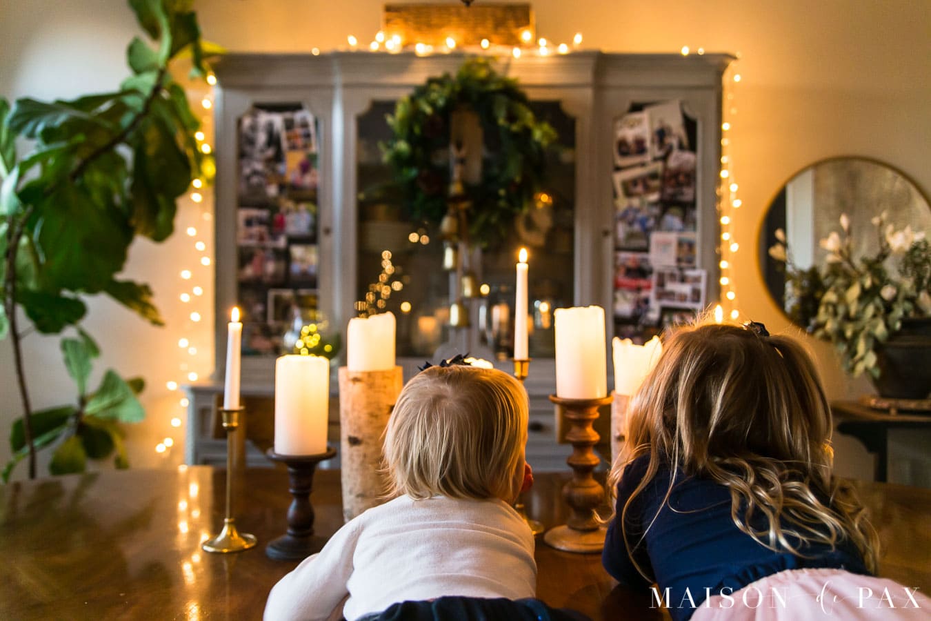 girls looking at candles in Christmas dining room | Maison de Pax