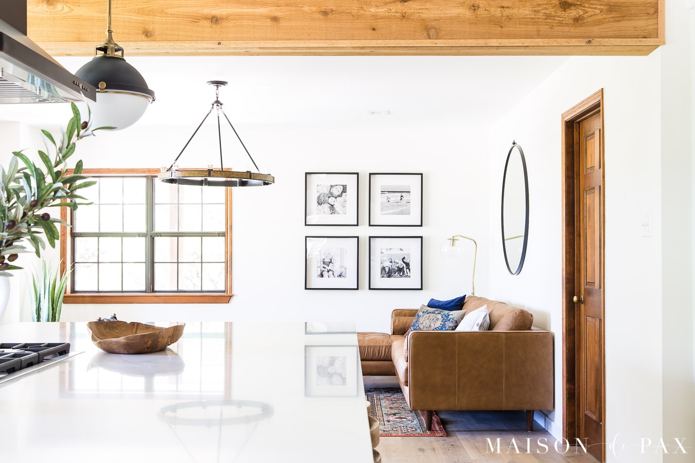 rustic beams, white walls, tan leather sectional | Maison de Pax