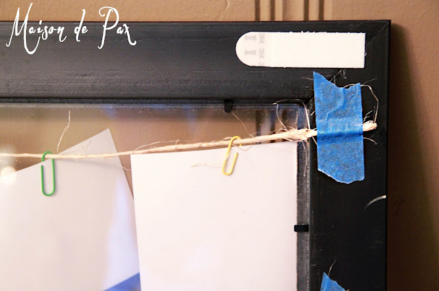 twine and paperclips hold photos