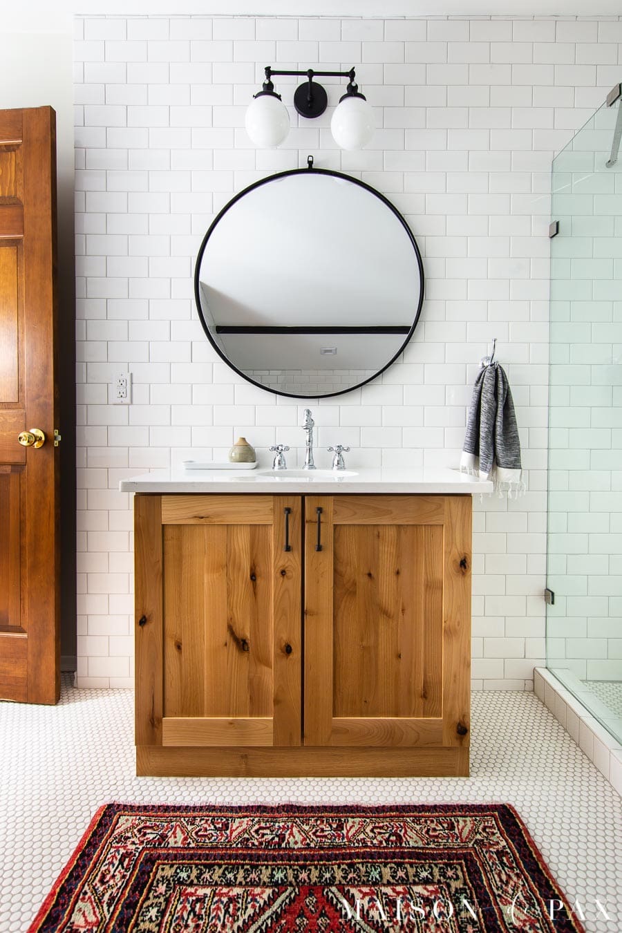 natural wood bathroom vanity with white subway tile backsplash to ceiling | Maison de Pax