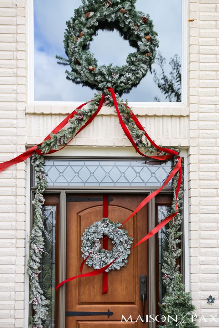 Greenery and Red Holiday Front Porch: What a beautiful, classic look! Get Christmas front porch decorating ideas here!