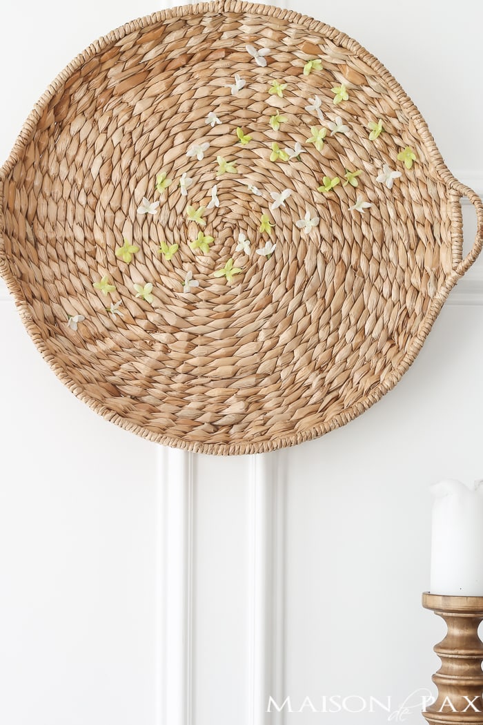 Looking for an easy spring decor idea? In about five minutes, you can turn a simple basket and inexpensive faux flowers into gorgeous spring wall art!