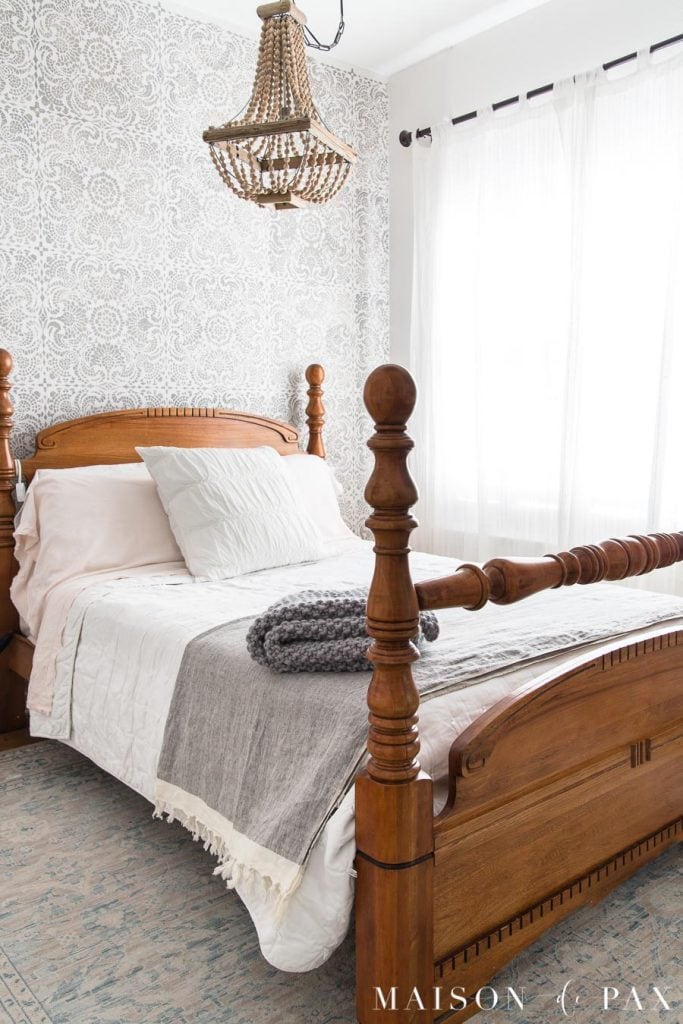 antique bed with white and gray bedding stencil accent wall | maison de pax