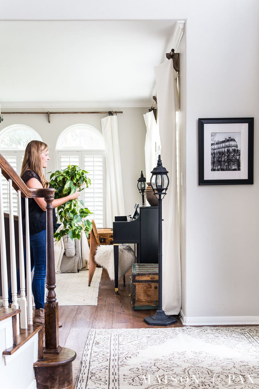 woman with philodendron in classic gray entryway with stairwell | Maison de Pax