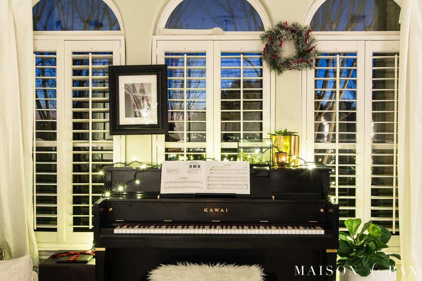 piano with string of Christmas lights | Maison de Pax