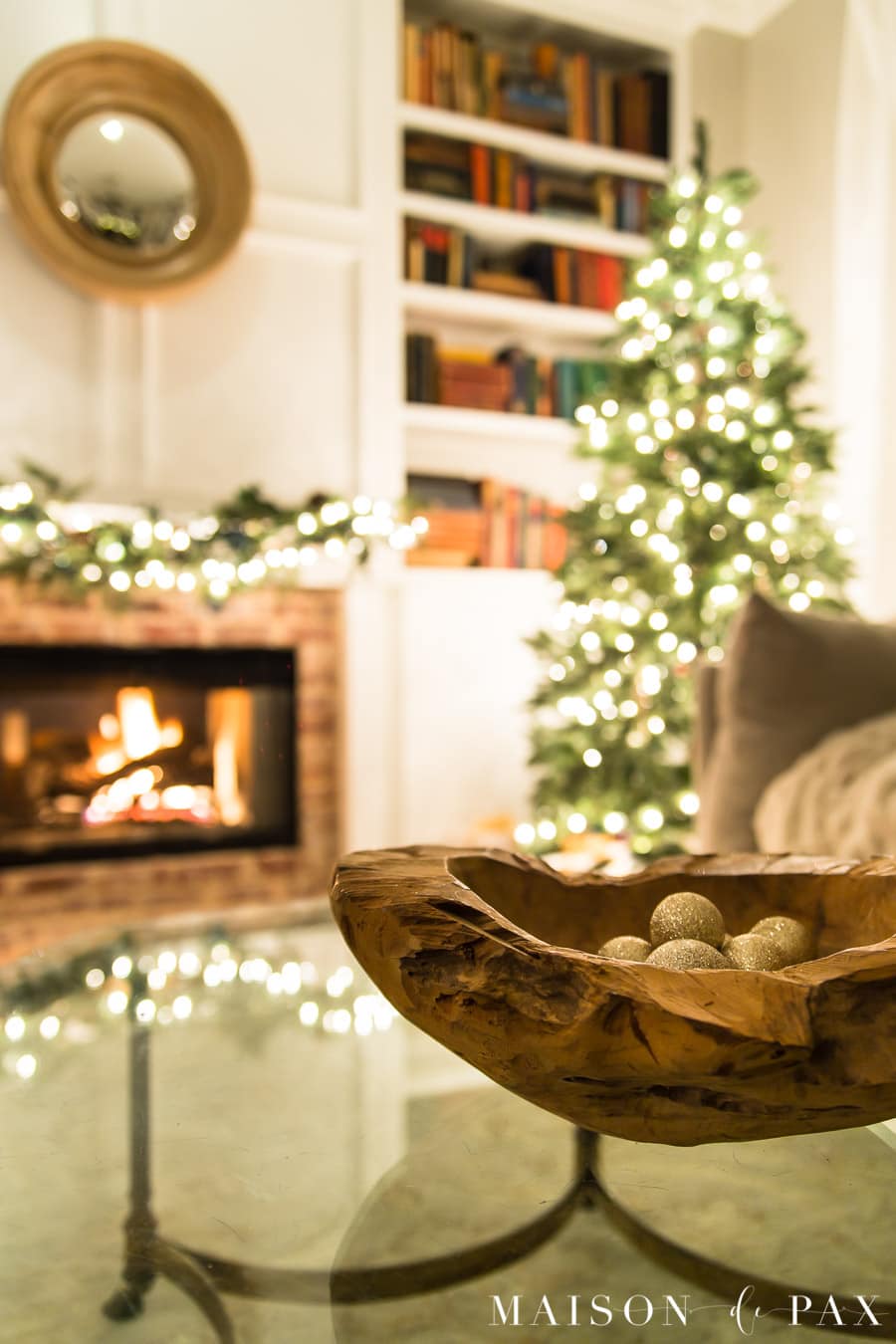 roaring fire in fireplace beside Christmas tree at night | Maison de Pax