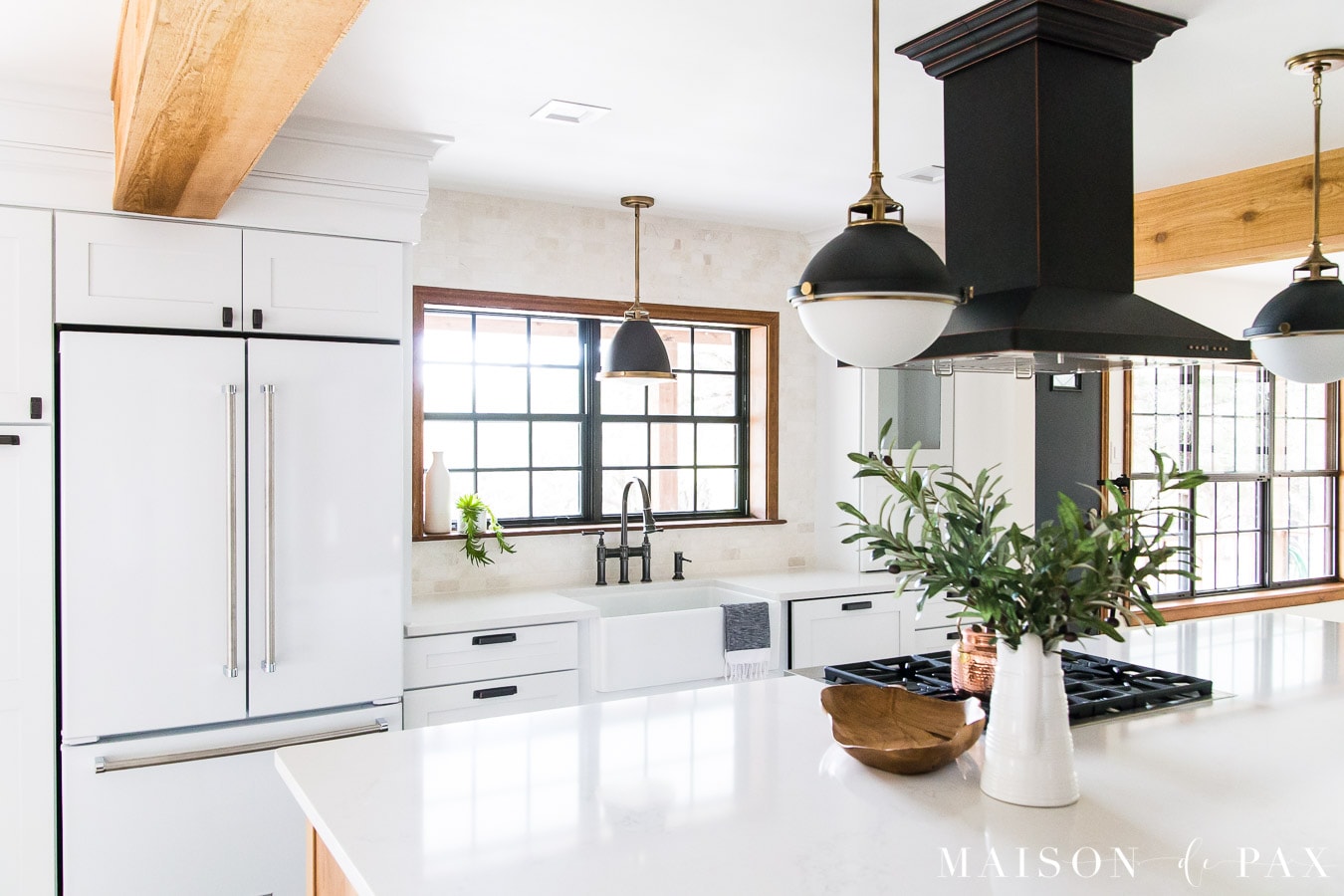 black island hood with white appliances | Maison de Pax