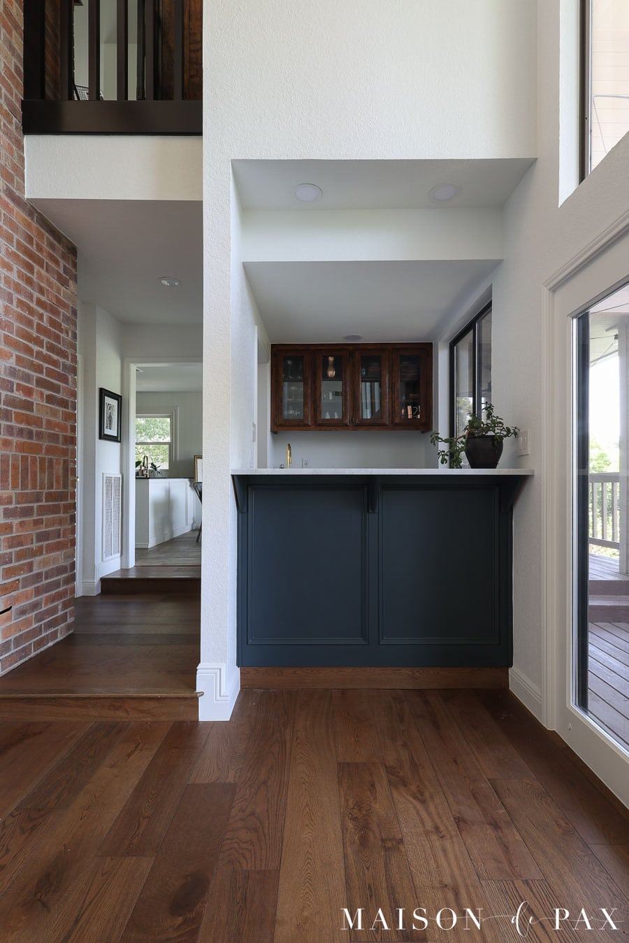 home bar with gray blue lower cabinets and stained upper cabinets