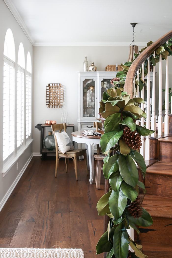 simple greenery and mercury glass makes this French farmhouse style dining room all set for Christmas!
