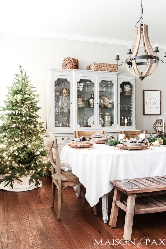 simple green tree and white tablecloth and natural centerpiece make this the perfect farmhouse Christmas dining room and holiday tablescape - Maison de Pax