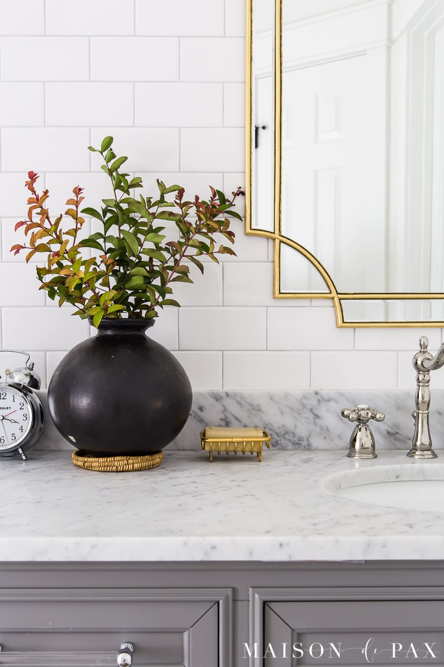 black pottery on marble top vanity