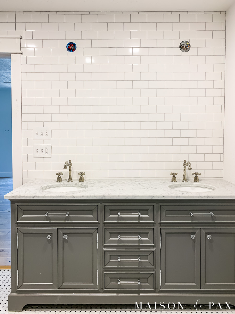 subway tile walls and gray double vanity with marble top | Maison de Pax