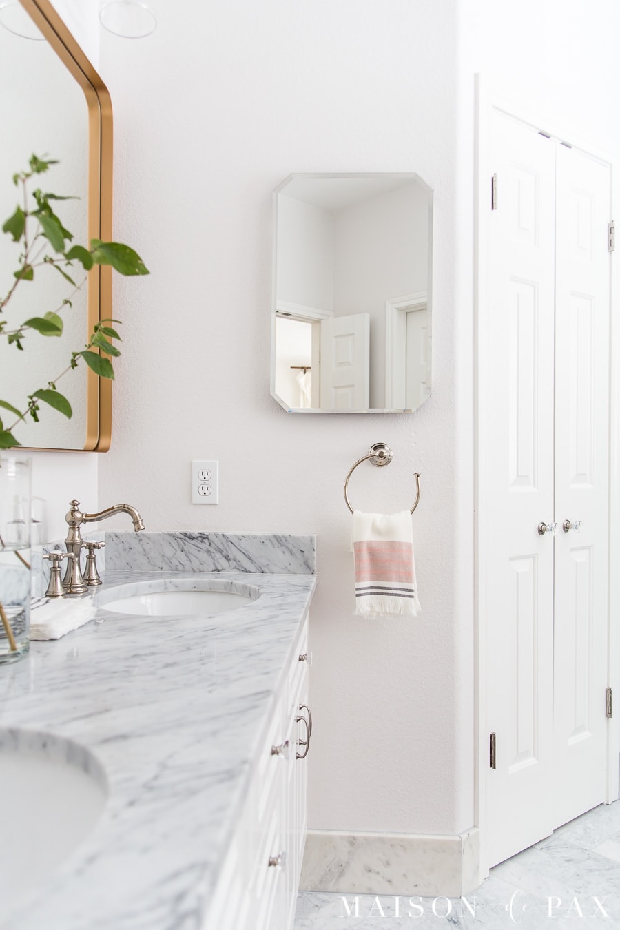 gold bathroom mirrors and polished nickel towel rings | Maison de Pax
