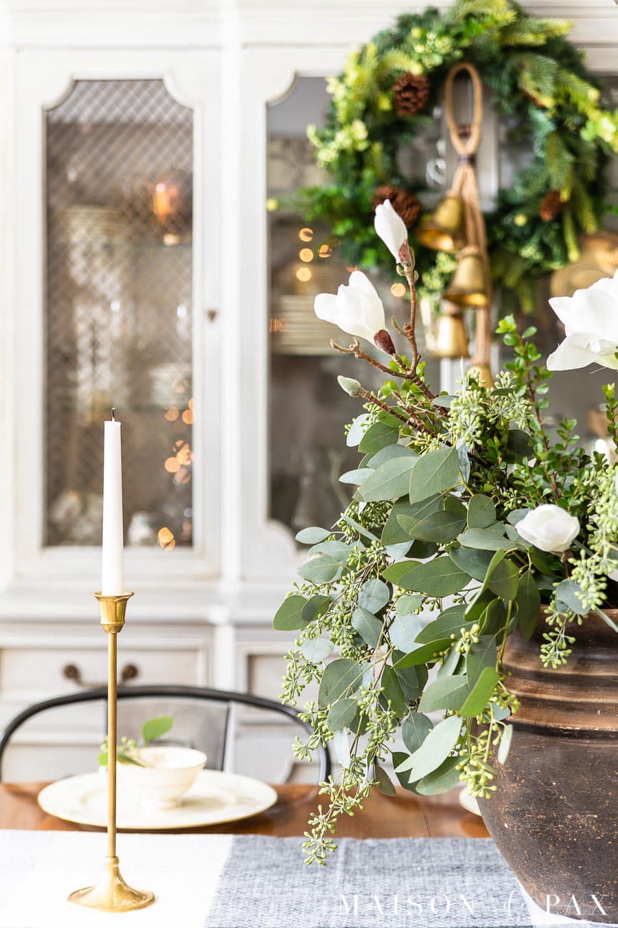 green and white holiday centerpiece in black pot | Maison de Pax