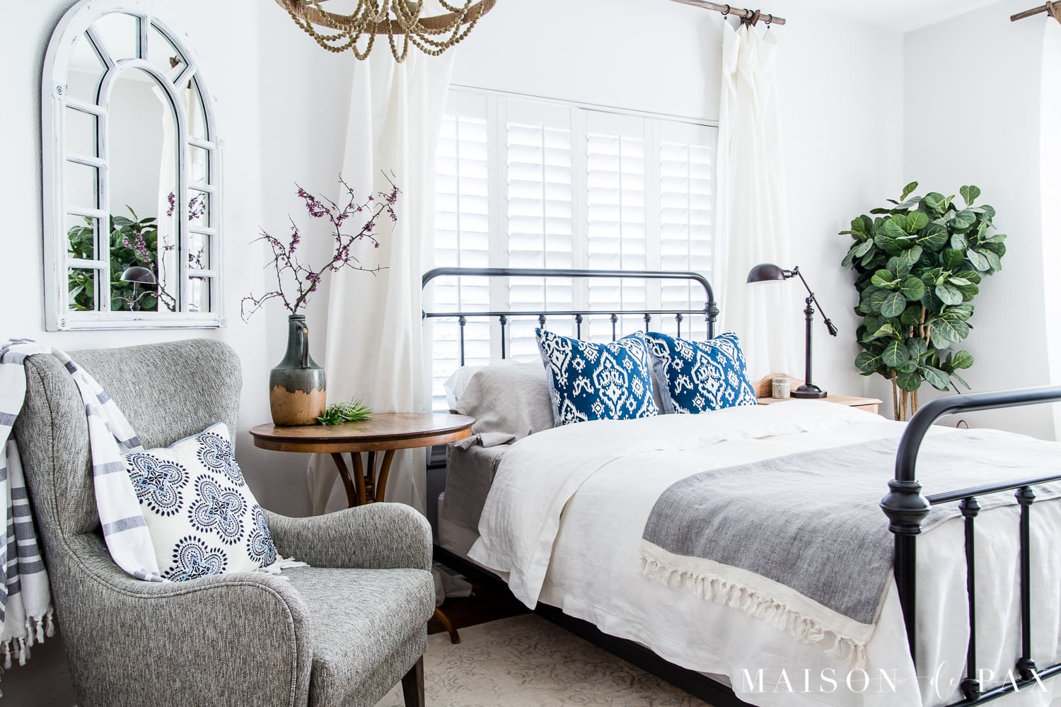 Mostly white bedroom with pops of blue for spring/summer... Looking to add a seasonal touch to your bedroom?  Don't miss these incredibly simple master bedroom decorating ideas for spring! #springdecor #springbedroom #nightstand #modernfarmhouse