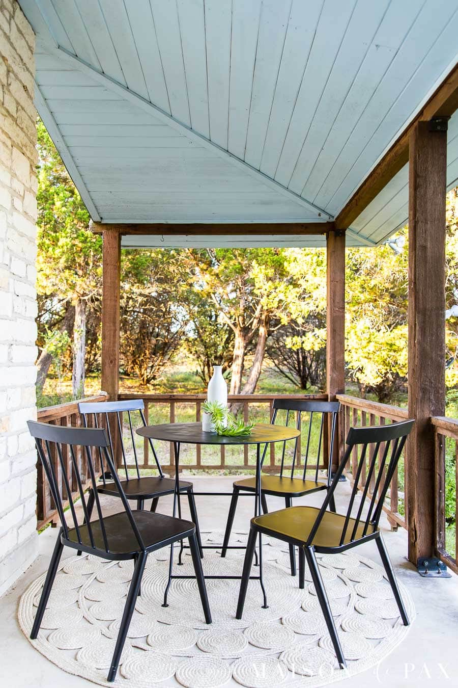 black metal outdoor chairs and bistro table on wrap around porch with haint blue ceiling | Maison de Pax