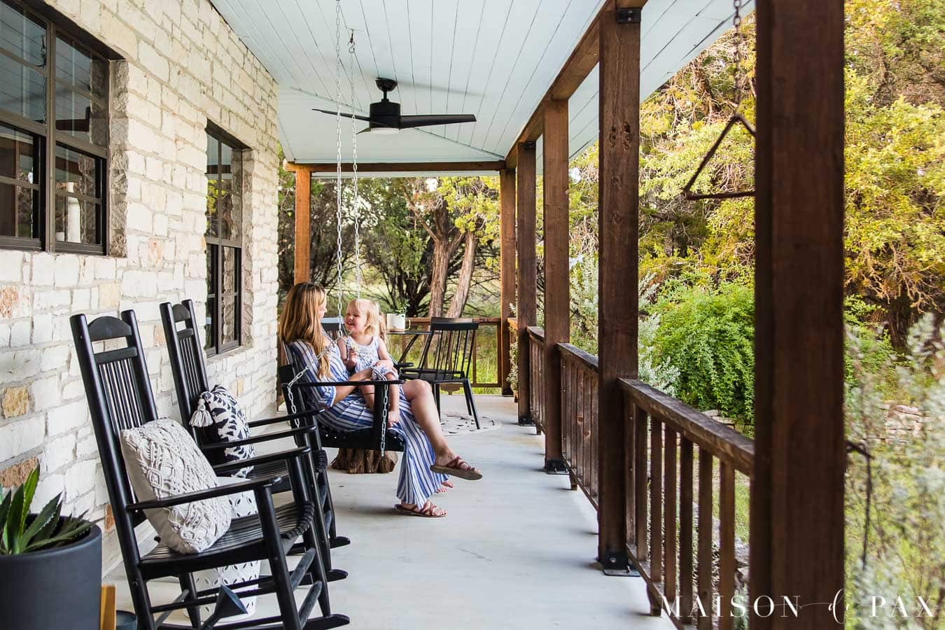 mother and daughter sitting on porch swing | Maison de Pax