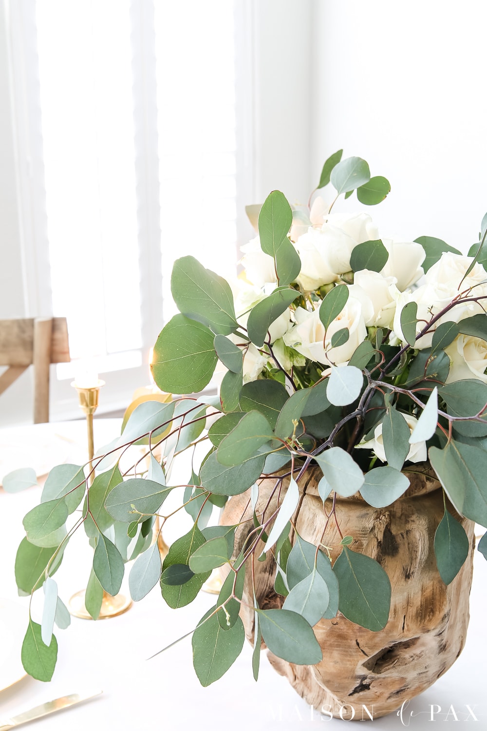 raw wood vase and white roses and eucalyptus centerpiece- Maison de Pax