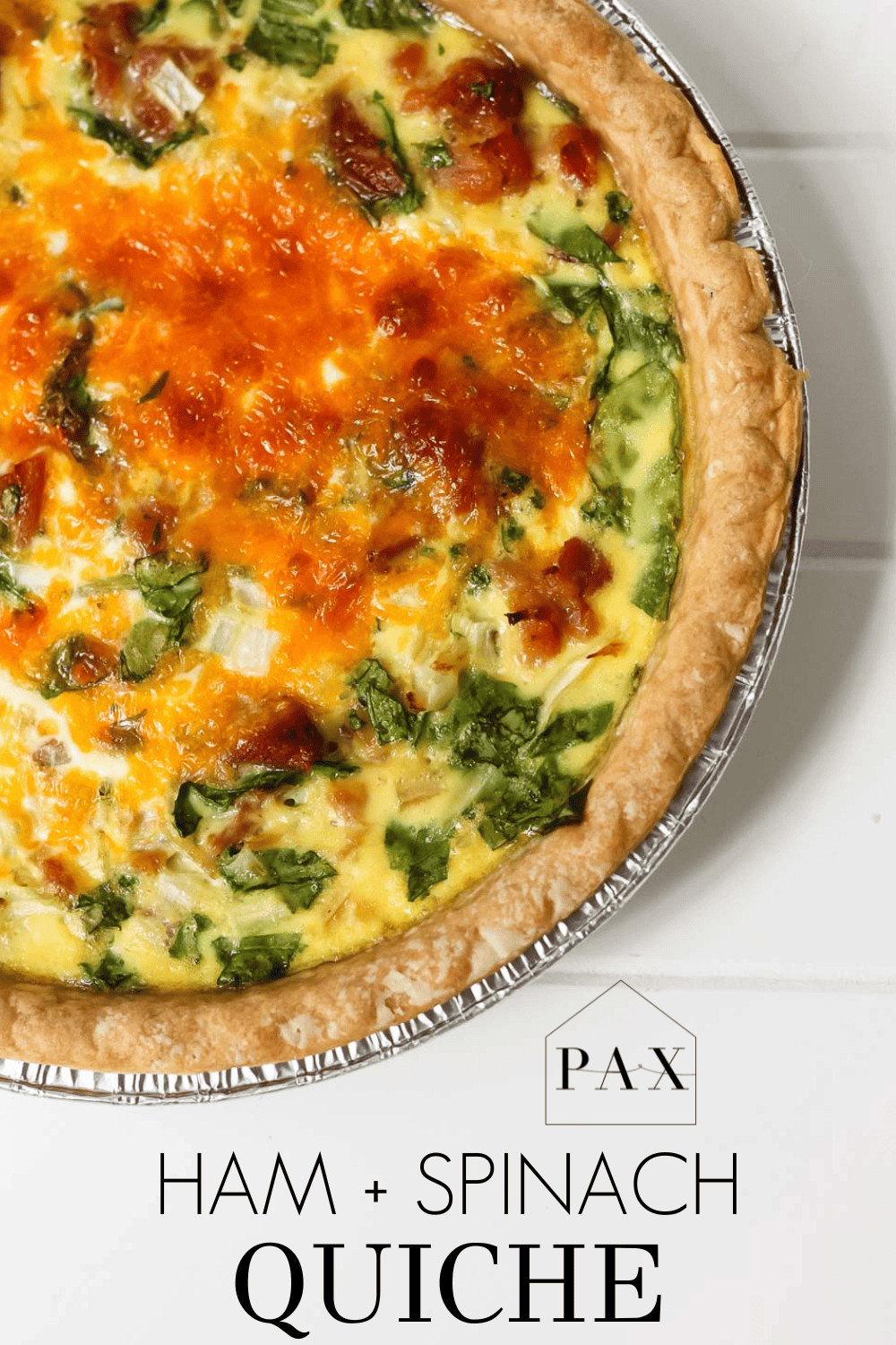 beautiful golden brown quiche with text overlay: ham and spinach quiche