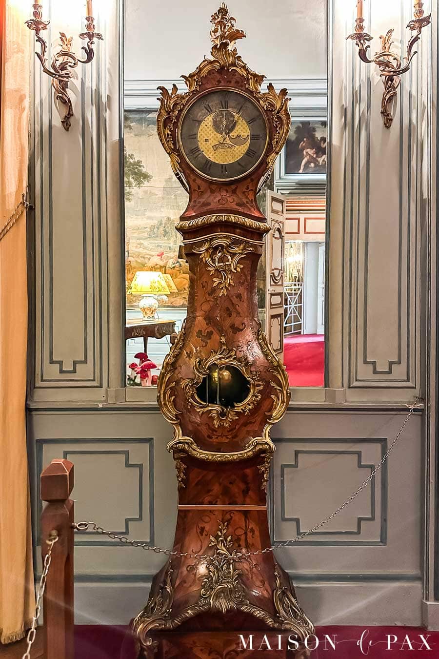elegant french clock and beautiful wall paneling with decorative moulding
