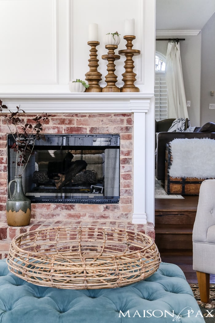 simple, neutral fall mantel decor ideas: woven basket, wood candlesticks, and glazed pitcher- Maison de Pax