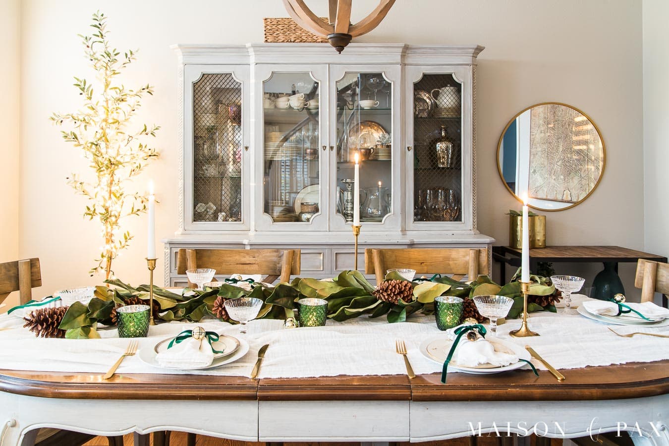 candlelit Christmas table with garland centerpiece | Maison de Pax
