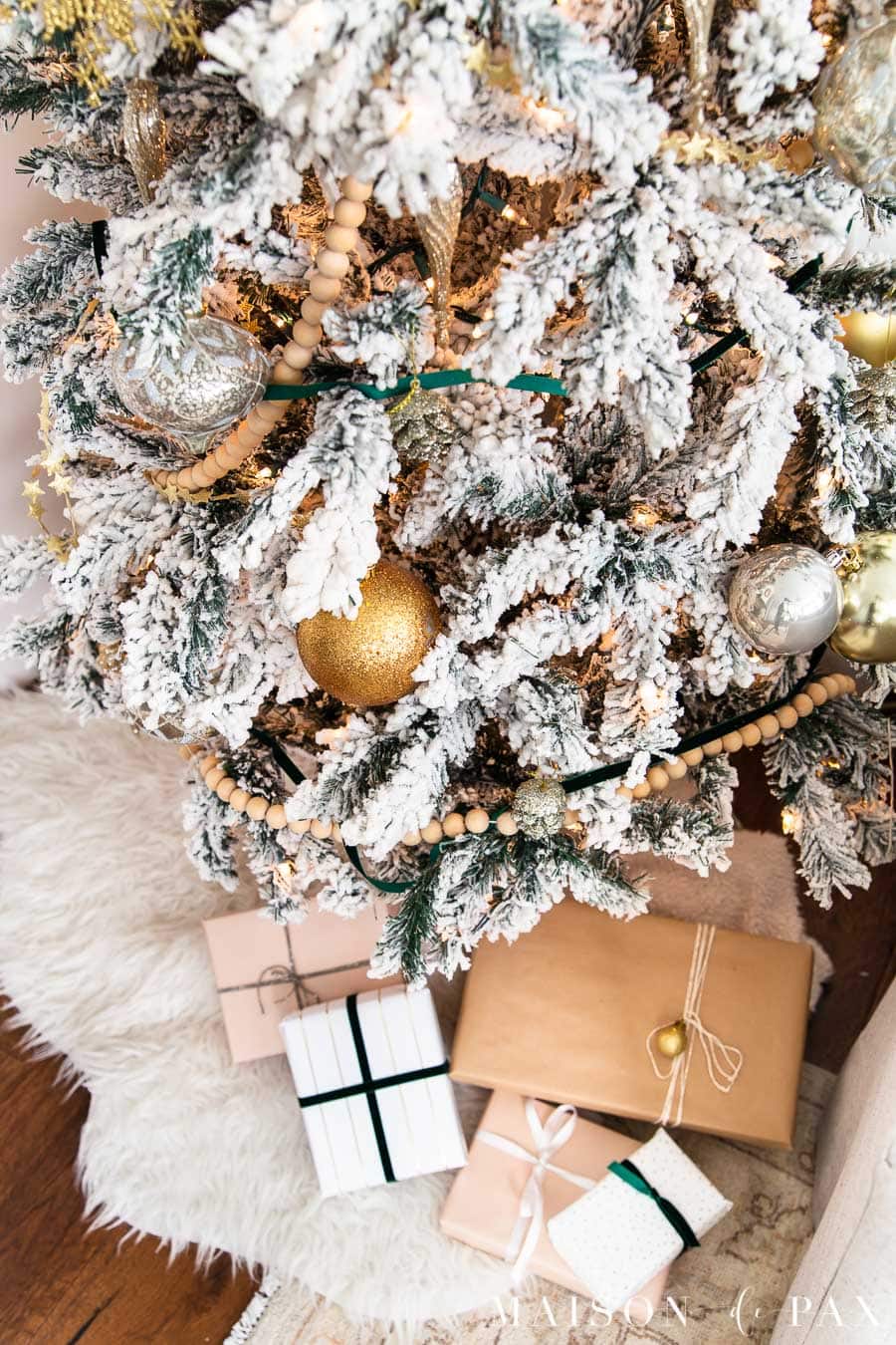 flocked tree with wood bead garland and green velvet ribbon | Maison de Pax