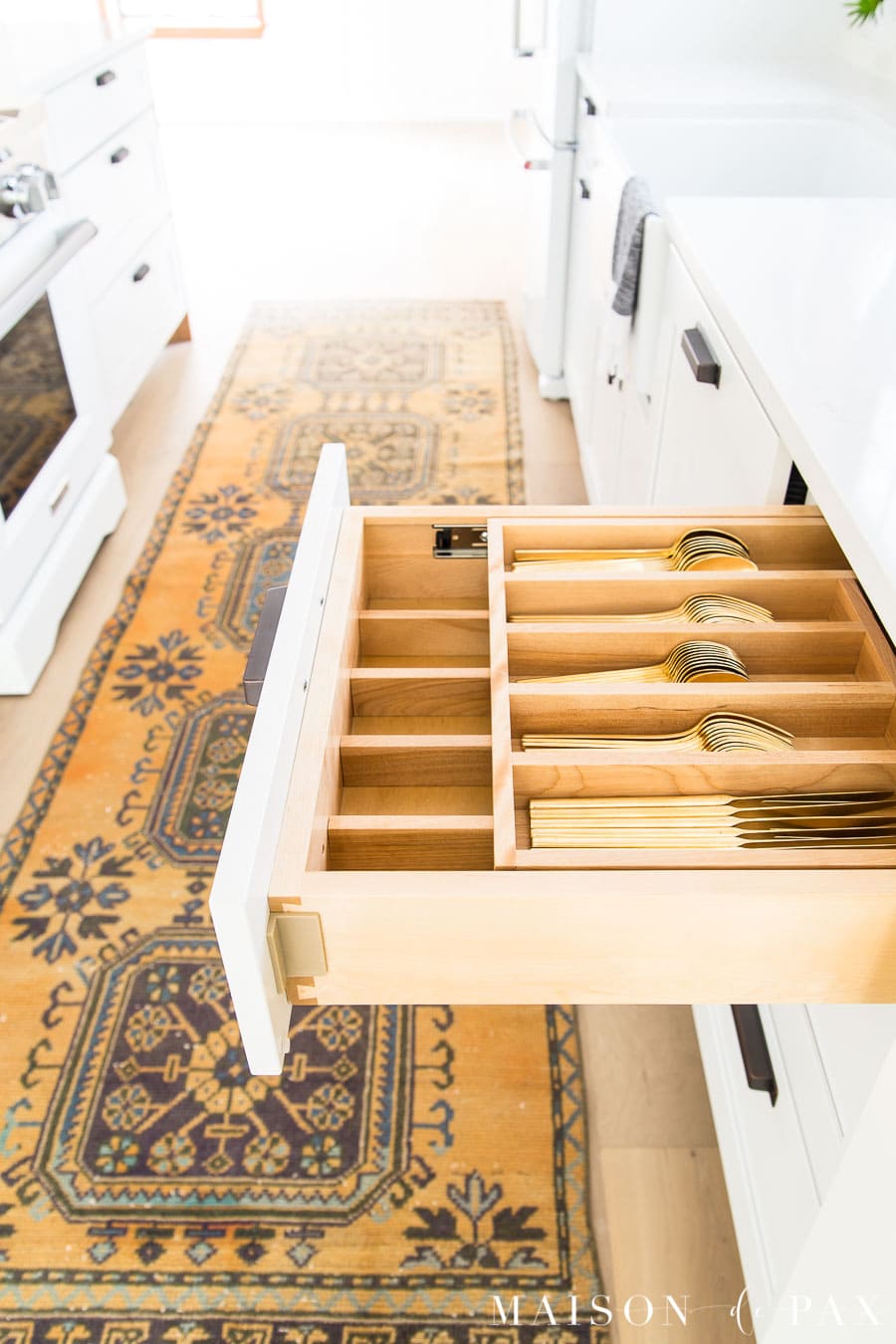 gold silverware in layered cutlery drawer | Maison de Pax