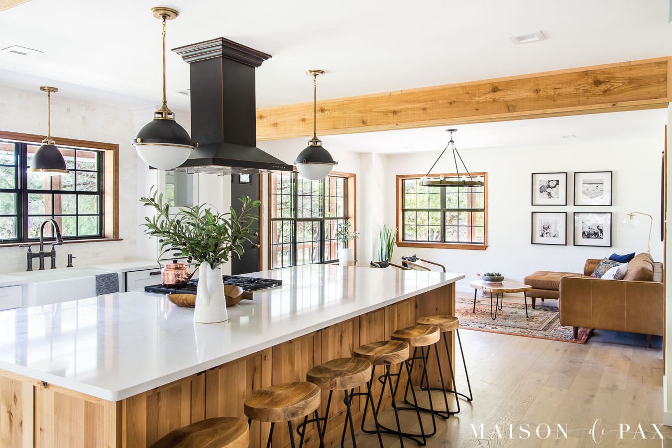 big island open kitchen with rustic mid century modern living room beyond | Maison de Pax