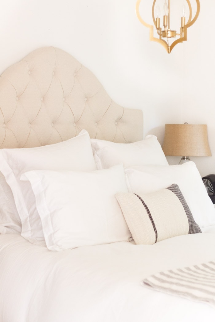 White bedding and quilted headboard- Maison de Pax