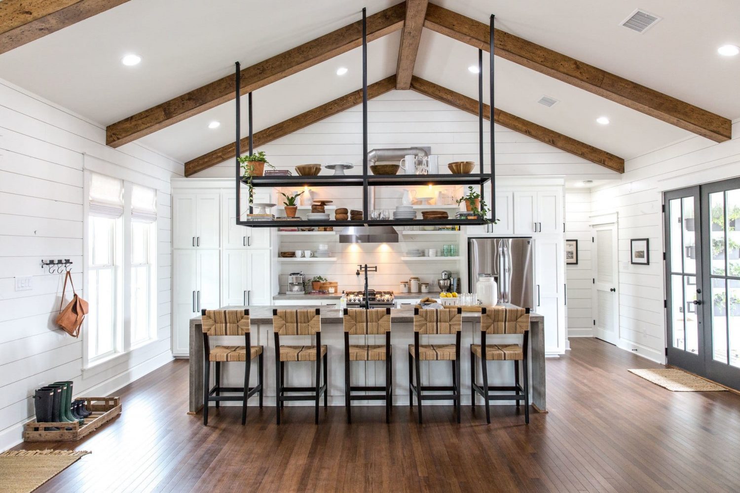 Magnolia kitchen by Joanna Gaines: giant island seating 5 facing wall of cabinetry