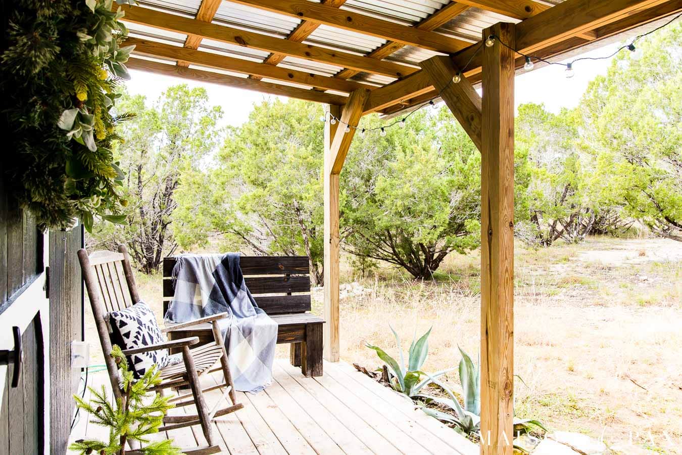 farmhouse porch with a view into the woods