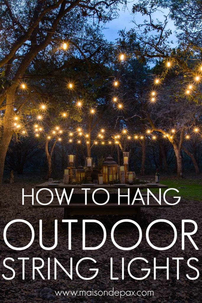 gorgeous globe string lights over a picnic table outdoors | Maison de Pax