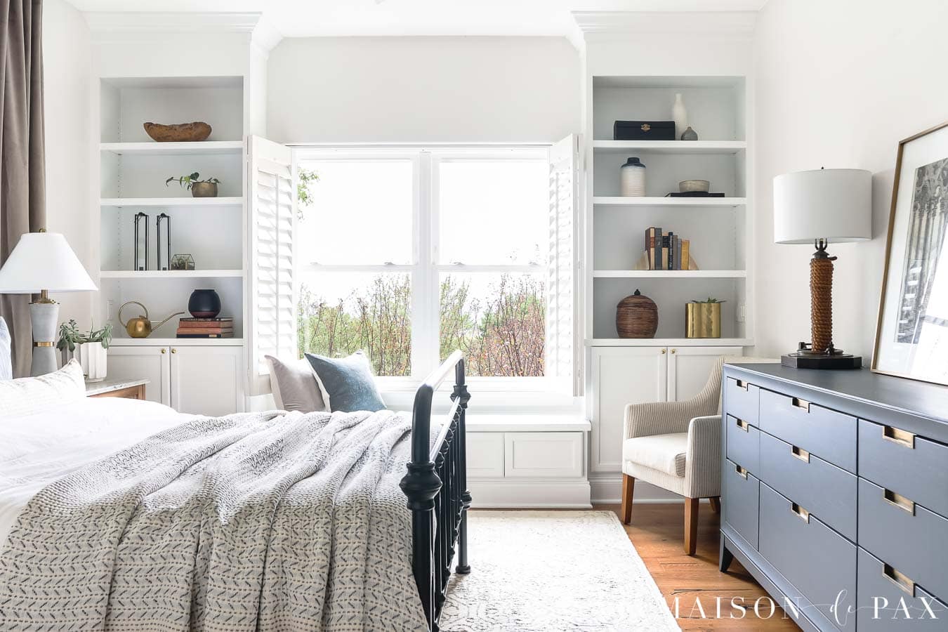 window with plantation shutters and built-in bookcases on either side