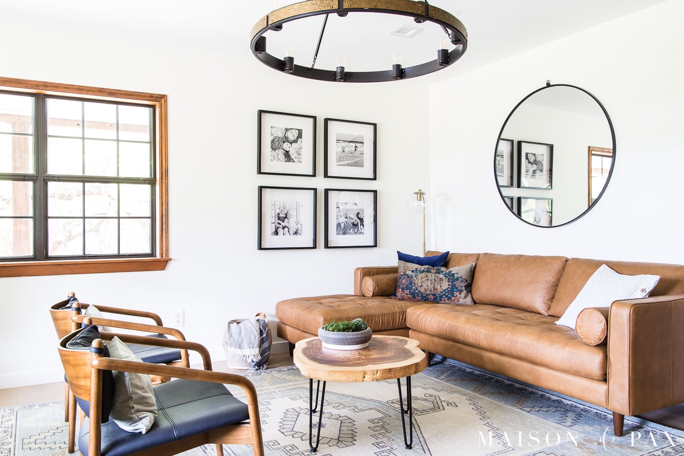 light brown leather sectional and black leather armchairs | Maison de Pax