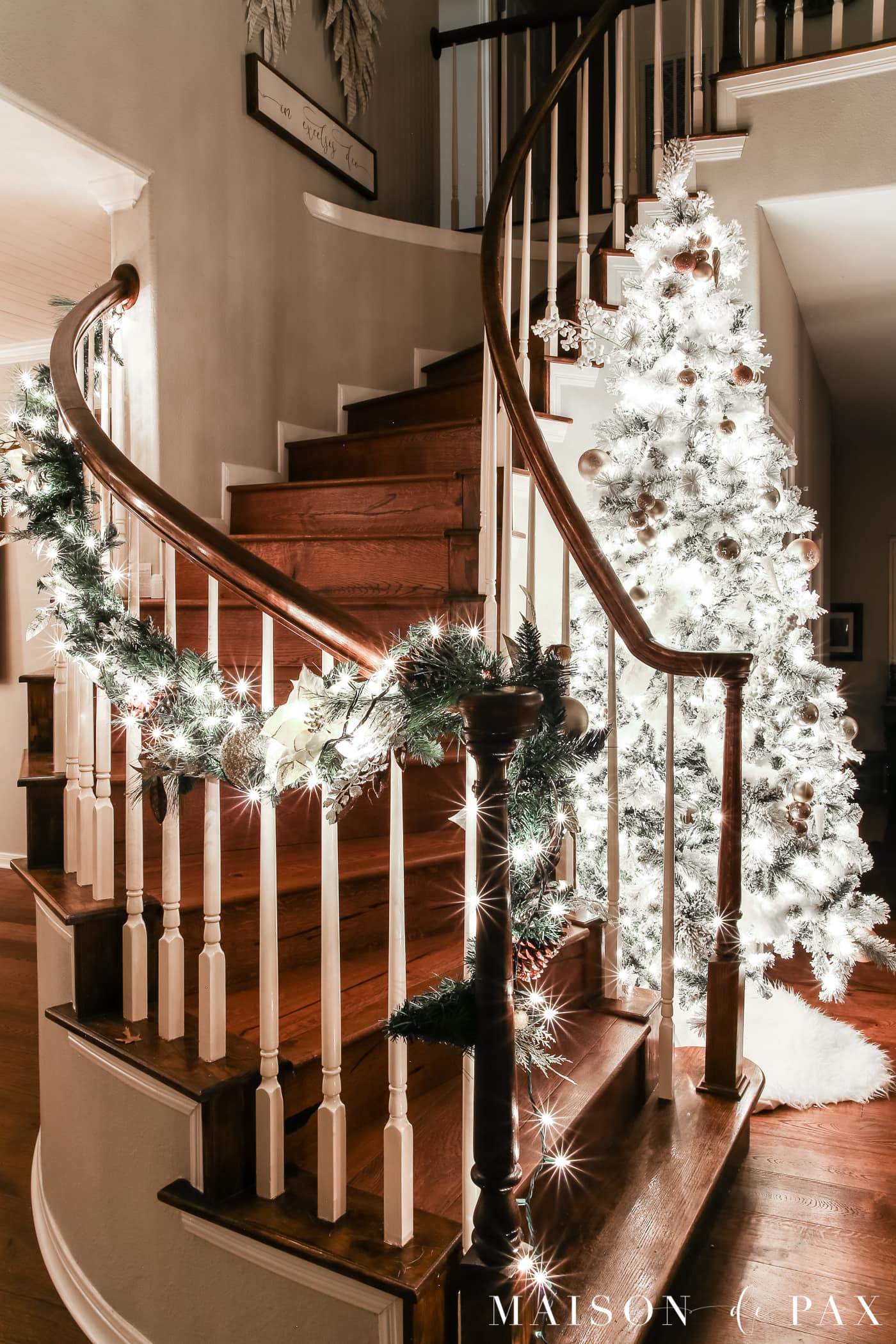 tall tree and wrap around spiral staircase: gorgeous Christmas lights at night in these 25+ home tours #christmasnightstour #holidayhometour #christmaslights