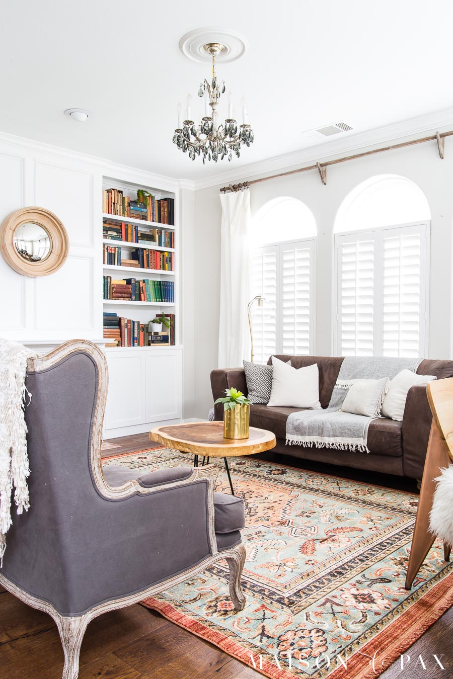 vintage rug look with antique books and modern accents living room | Maison de Pax
