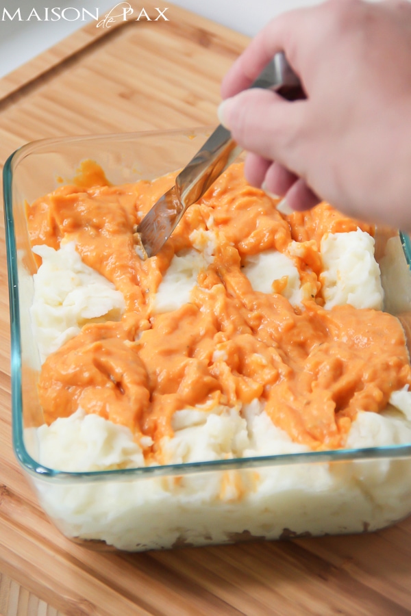 Deliciously seasoned sweet and golden potatoes. Swirled. Baked. You'll never make two separate dishes again! via aiweb9ygdry.cmersite.com #recipe #mashed #potatoes #sweet #thanksgiving #fall