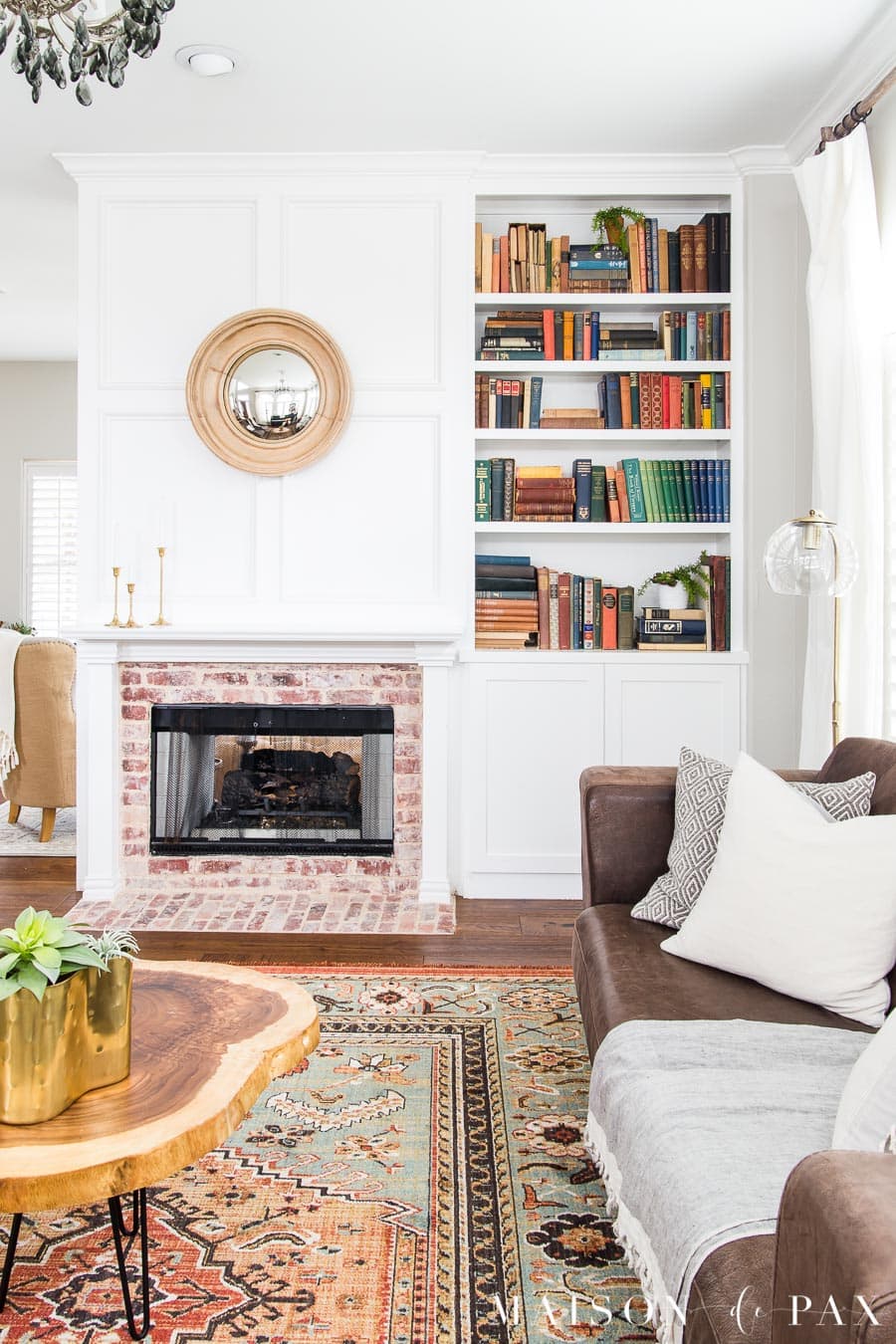 living room fireplace and bookcase with antique books | Maison de Pax