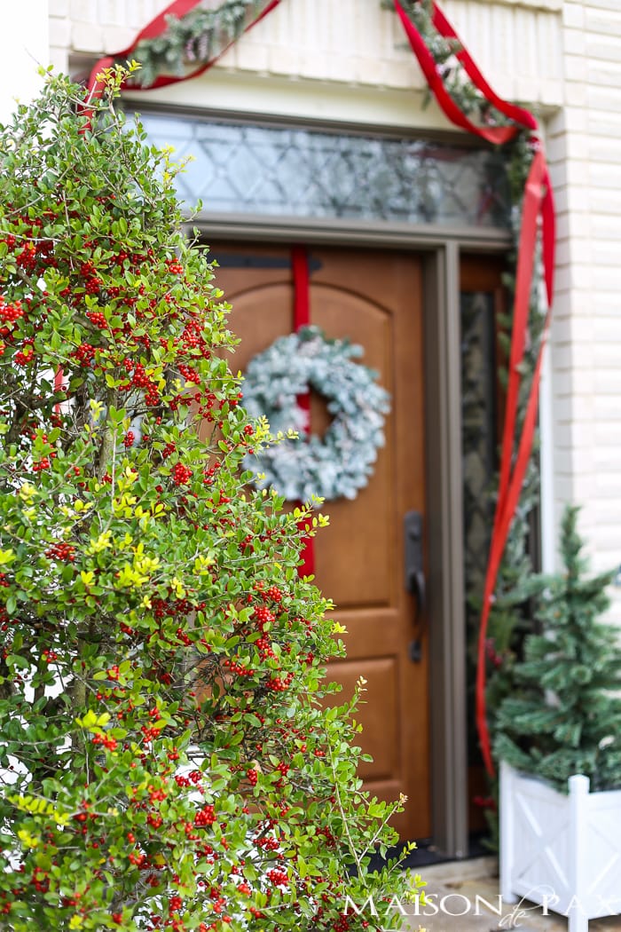 Greenery and Red Holiday Front Porch: What a beautiful, classic look! Get Christmas front porch decorating ideas here!